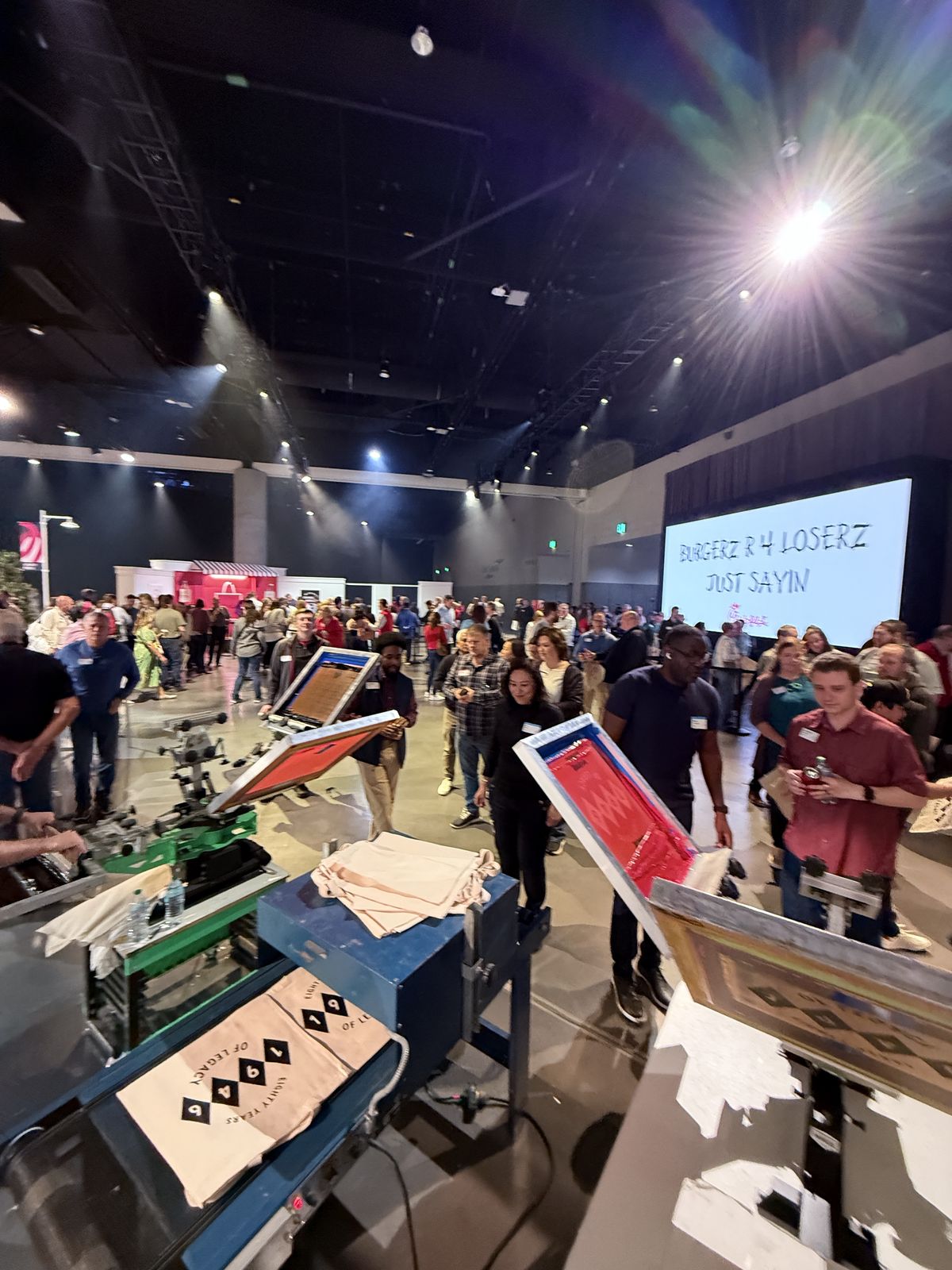 Live customization station drawing a dense crowd inside a hotel ballroom